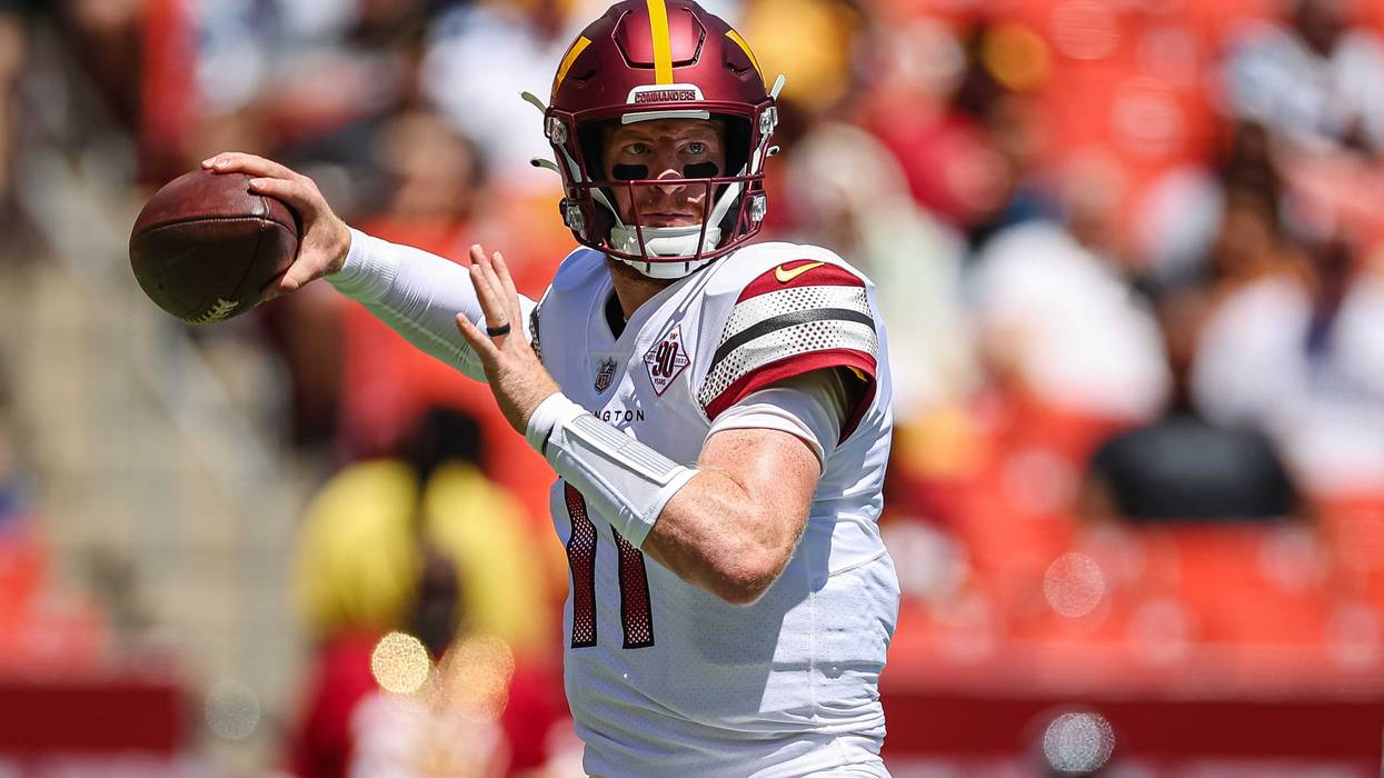 Washington Commanders quarterback Carson Wentz prepares to pass against the Carolina Panthers in a 2022 preseason game.