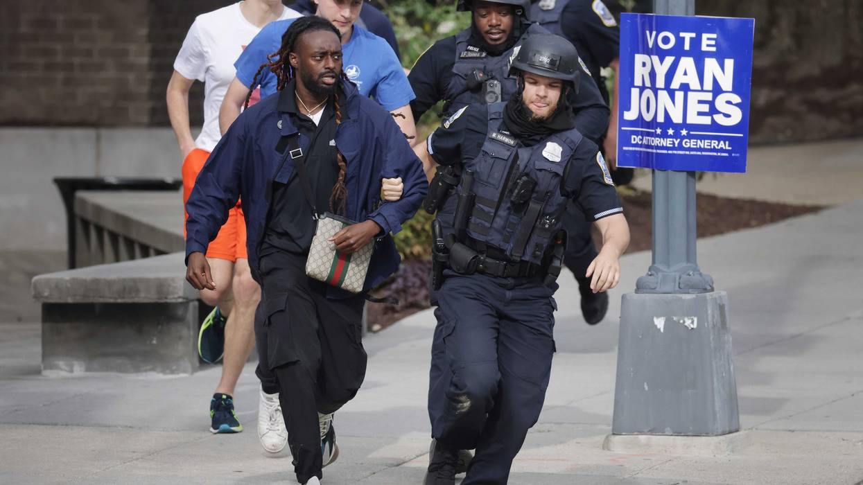 WASHINGTON, DC - APRIL 22: Metropolitan Police run as they escort people, some without shoes, away from a shooting scene in the northwest part of the city on April 22, 2022 in Washington, DC. Police evacuated residents from the shooting scene Friday afternoon and there were reports of several shooting victims.