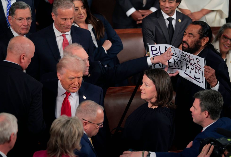 WASHINGTON, DC - FEBRUARY 24: Rep. Al Green (D-TX) holds up a sign as Trump delivers his State of the Union address during a Joint Session of Congress at the U.S. Capitol on February 24, 2026, in Washington, DC. Trump delivered his address days after the Supreme Court struck down the administration