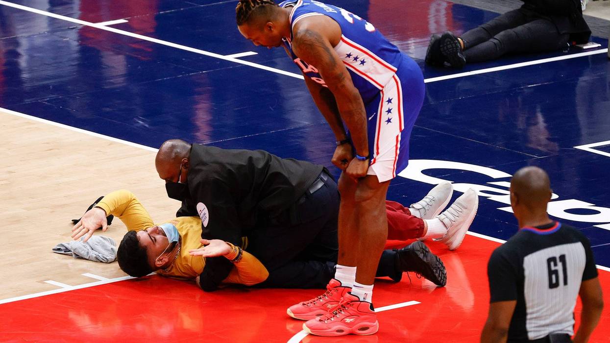 WASHINGTON, DC - MAY 31: Dwight Howard #39 of the Philadelphia 76ers looks down at a fan who ran onto the court and was tackled by security in the third quarter of Game Four of the Eastern Conference first round series against the Washington Wizards at Capital One Arena on May 31, 2021 in Washington, DC.