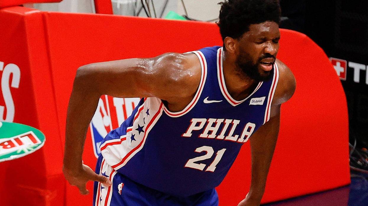 WASHINGTON, DC - MAY 31: Joel Embiid #21 of the Philadelphia 76ers clutches his back during the first quarter against the Washington Wizards during Game Four of the Eastern Conference first round series at Capital One Arena on May 31, 2021 in Washington, DC.