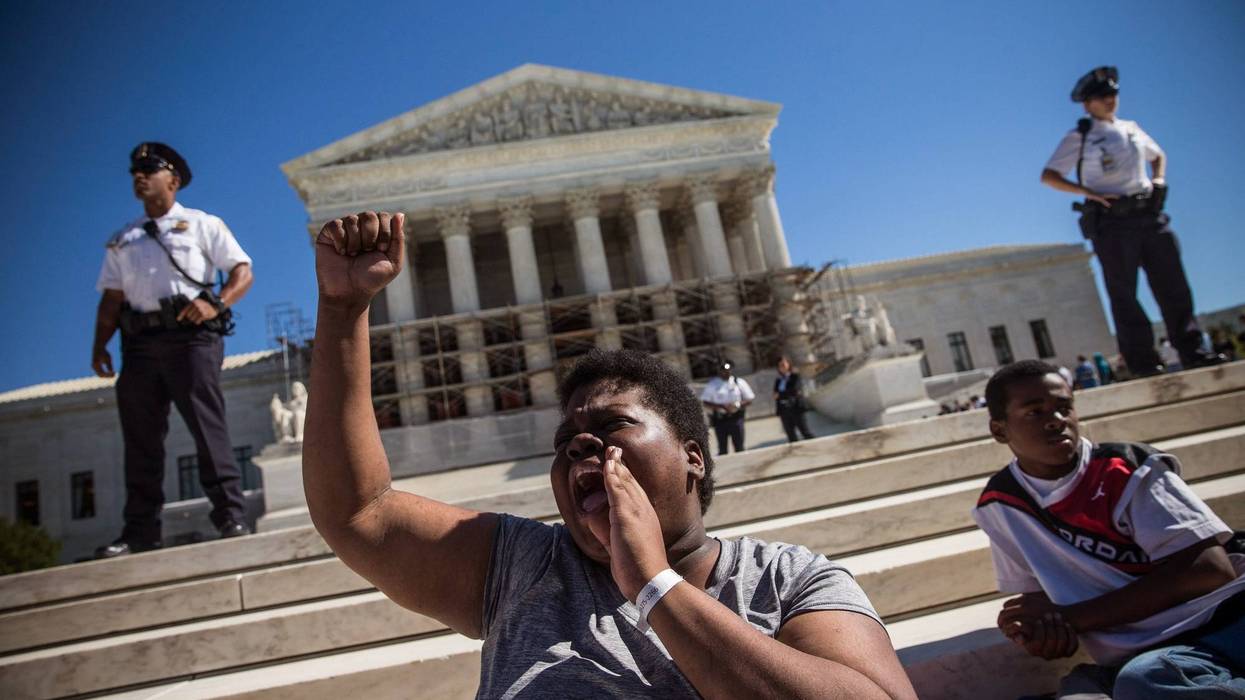 WASHINGTON, DC - OCTOBER 15: A woman protests in support of affirmative action, outside the Supreme Court during the hearing of "Schuette v. Coalition to Defend Affirmative Action" on October 15, 2013 in Washington, DC. The case revolves around affirmative action and whether or not states have the right to ban schools from using race as a consideration in school admissions.