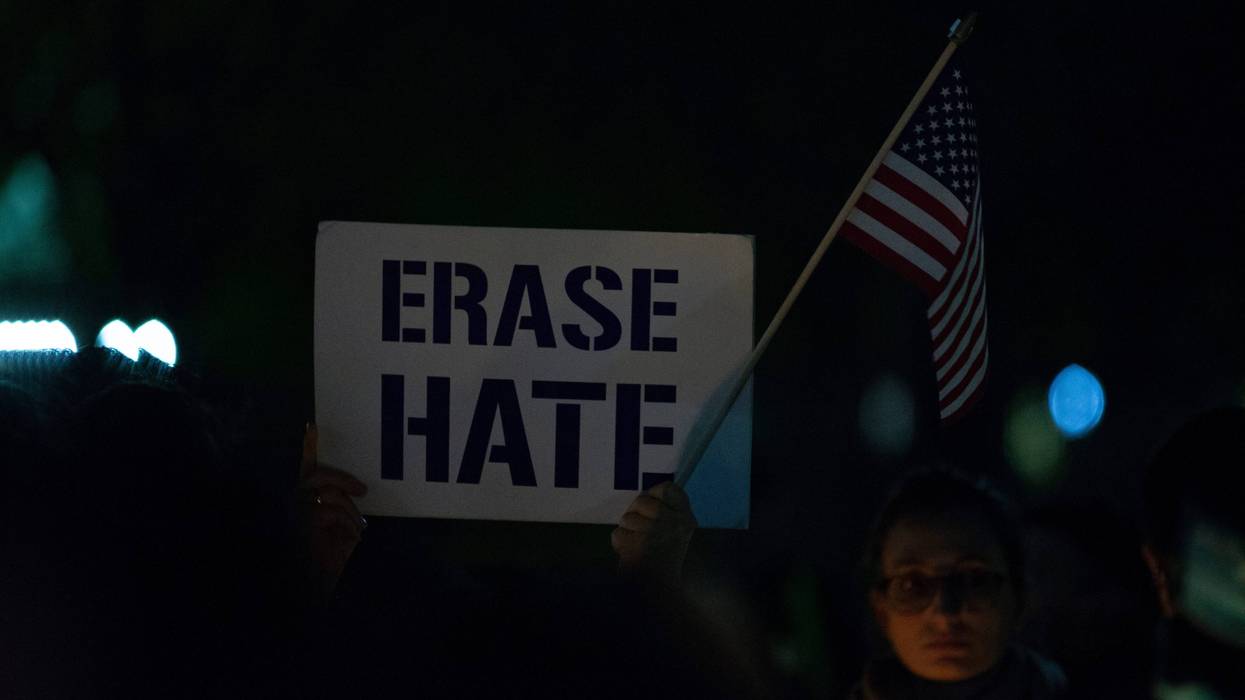 WASHINGTON, DC - OCTOBER 27: A vigil participant holds a 'Erase Hate' sign during a Havdalah vigil for the victims of the Tree of Life Congregation shooting in front of the White House on October 27, 2018 in Washington, DC.