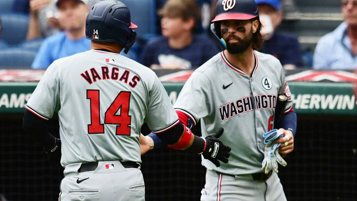 Washington Nationals shortstop Ildemaro Vargas (14) celebrates with left fielder Jesse Winker (6) after scoring during the second inning against the Cleveland Guardians at Progressive Field.