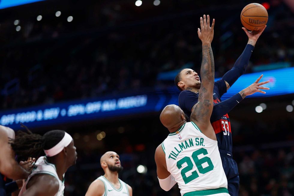 Washington Wizards forward Kyle Kuzma (33) shoots the ball as Boston Celtics forward Xavier Tillman (26) defends in the second half at Capital One Arena.