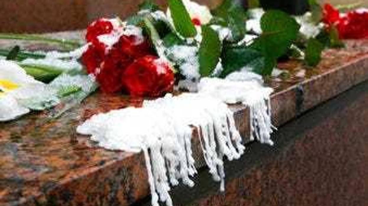 Wax from melted candles next to flowers are placed at the Canadian Embassy during a national day of mourning in Kyiv, Ukraine for the victims of the Ukrainian 737-800 plane that crashed on the outskirts of Tehran. (AP Photo/Efrem Lukatsky)