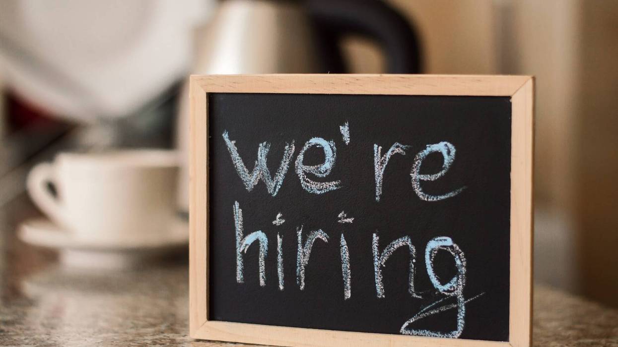 "We're Hiring" sign at restaurant
