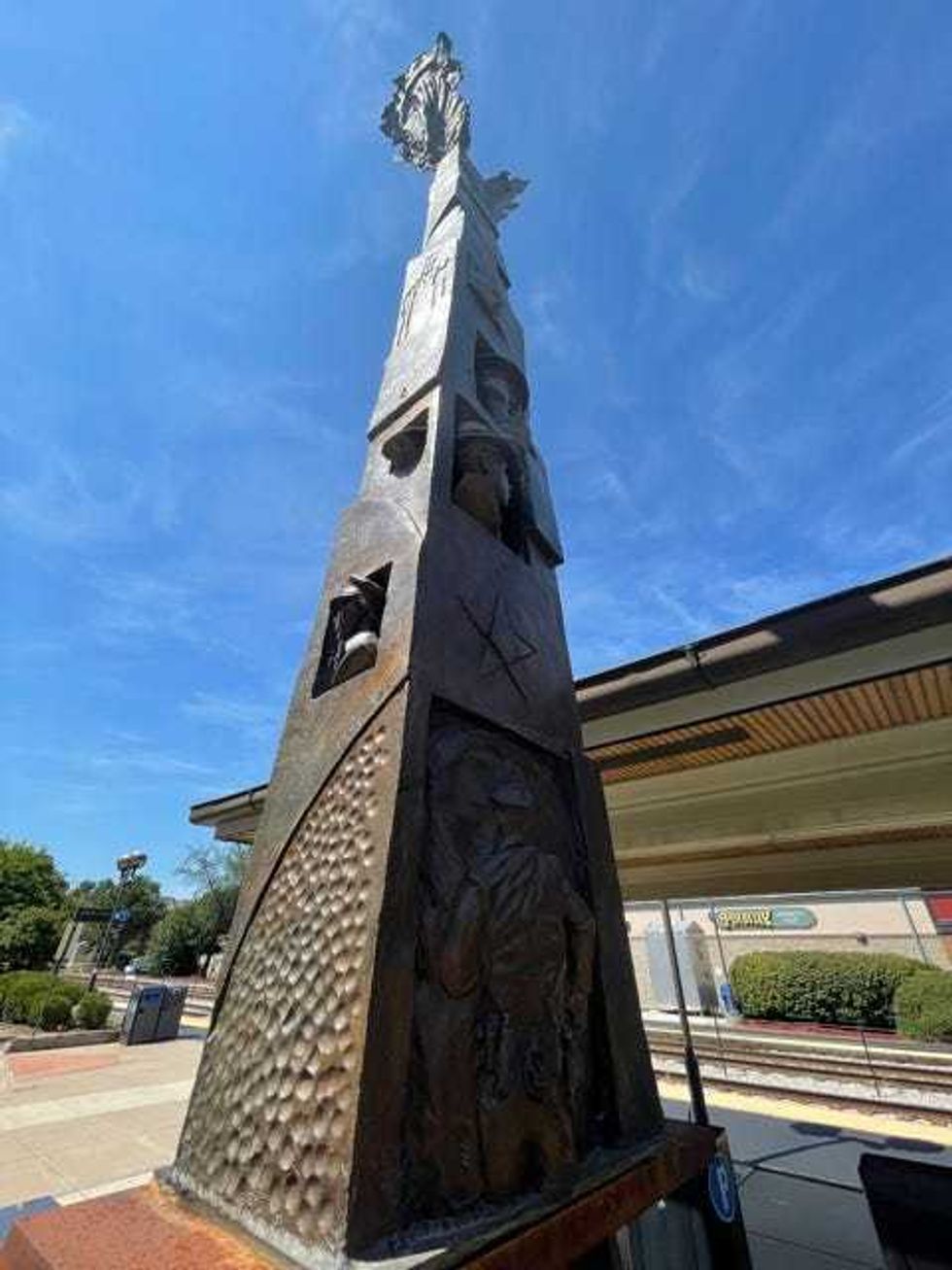 Wedged between 95th Street and Museum Drive and behind the Metra Station, an installation that incorporates four, 22-foot beams of World Trade Center Steel.