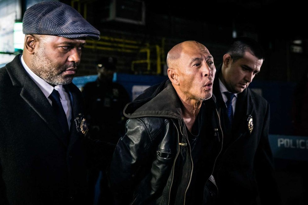 Weng Sor is walked by New York Police Department detectives out of the 68th Precinct in the Brooklyn borough of New York on Tuesday, Feb. 14, 2023