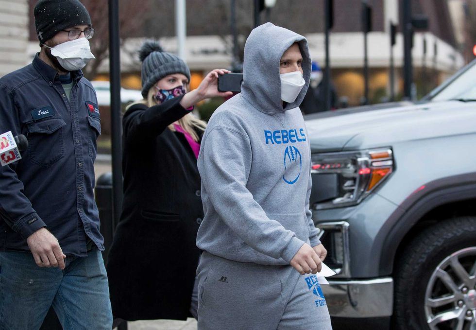 West Virginia Delegate Derrick Evans exits the Sidney L. Christie U.S. Courthouse and Federal Building after being arraigned on federal charges Friday, Jan. 8, 2021, in Huntington, W.Va.