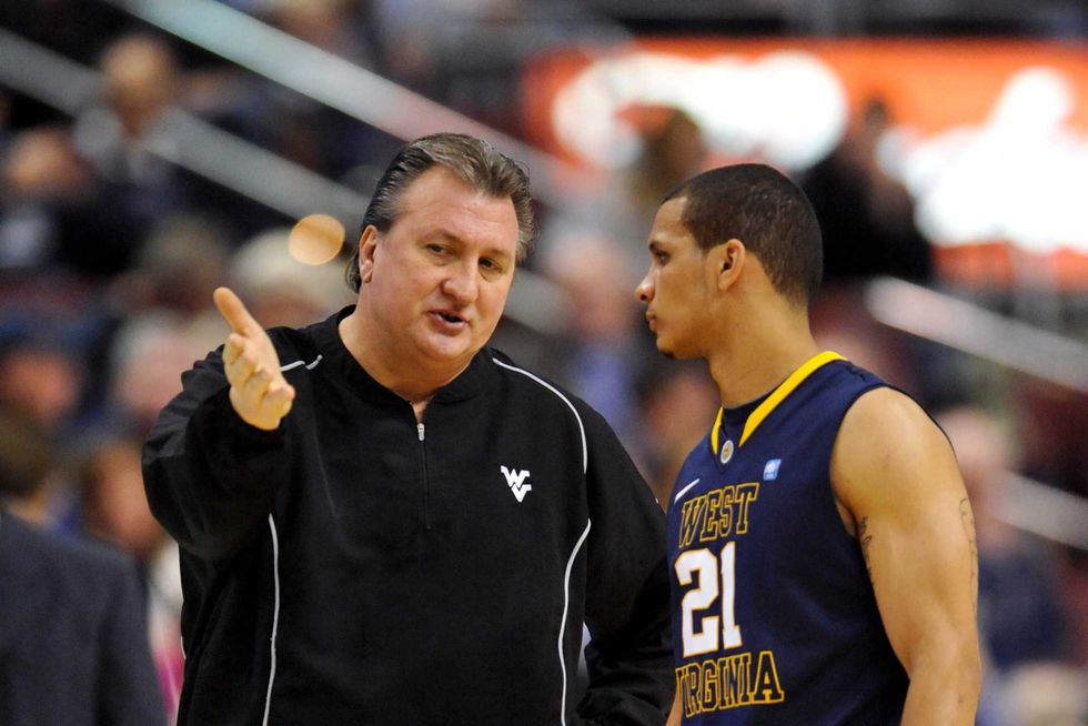 West Virginia Mountaineers head coach Bob Huggins talks with guard Joe Mazzulla (21) during the first half against the Villanova Wildcats at the Wells Fargo Center in February 2011.