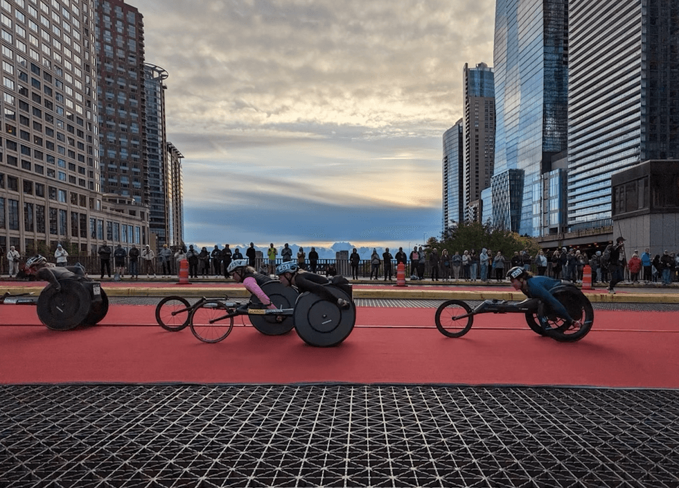 Wheelchair marathoners race across downtown during the 2023 Chicago Marathon.