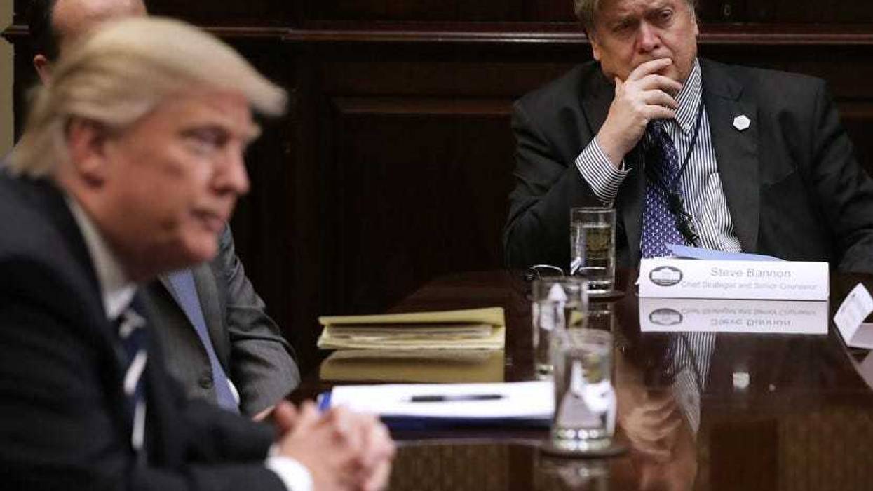 White House Chief Strategist Steve Bannon (R) listens to former Pres. Donald Trump during a meeting in the Roosevelt Room at the White House on Jan. 31, 2017.
