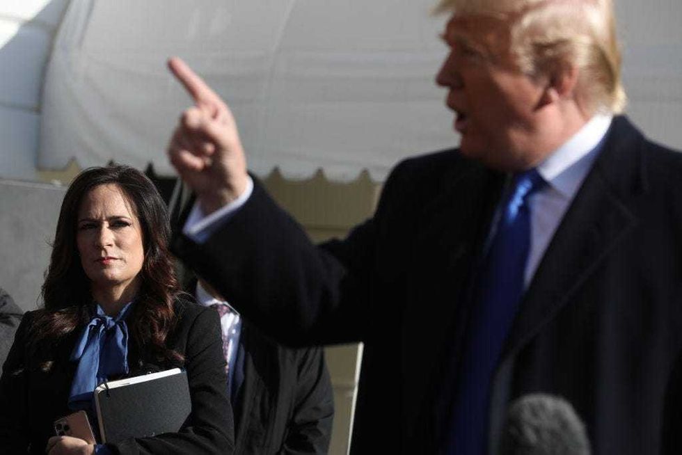 White House Press Secretary Stephanie Grisham (L) listens to U.S. President Donald Trump talk to reporters before he boards Marine One and departing the White House November 08, 2019 in Washington, DC.