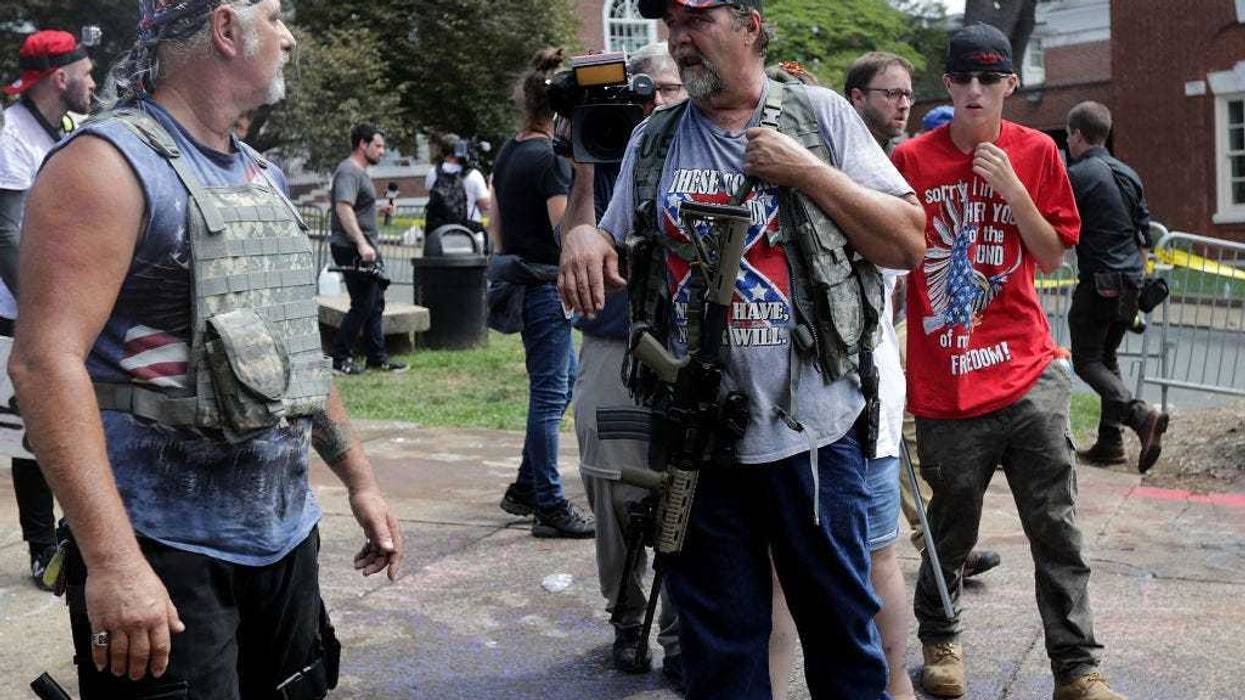 White nationalists, neo-Nazis, the KKK and members of the "alt-right" attempt to organize inside Emancipation Park during the Unite the Right rally August 12, 2017 in Charlottesville, Virginia. After clashes with anti-facist protesters and police the rally was declared an unlawful gathering and people were forced out of Lee Park, where a statue of Confederate General Robert E. Lee is slated to be removed. (Photo by Chip Somodevilla/Getty Images)