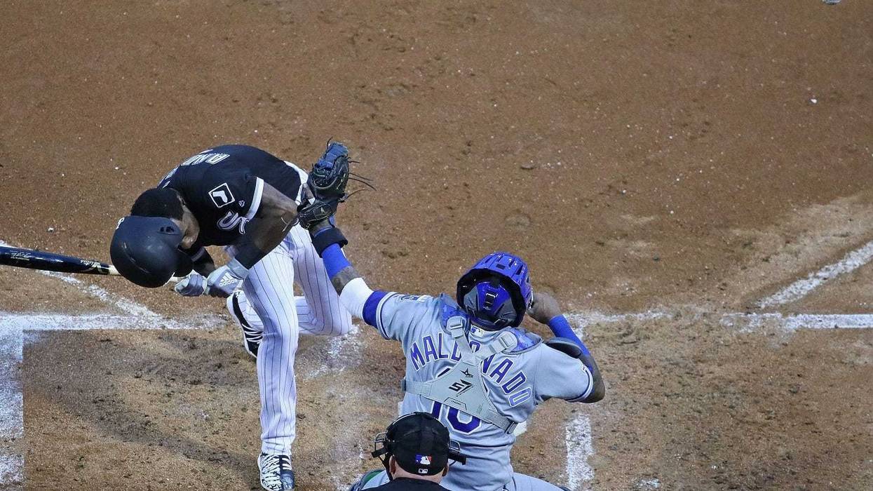 White Sox shortstop Tim Anderson recoils after being hit by a pitch by Royals right-hander Glenn Sparkman.