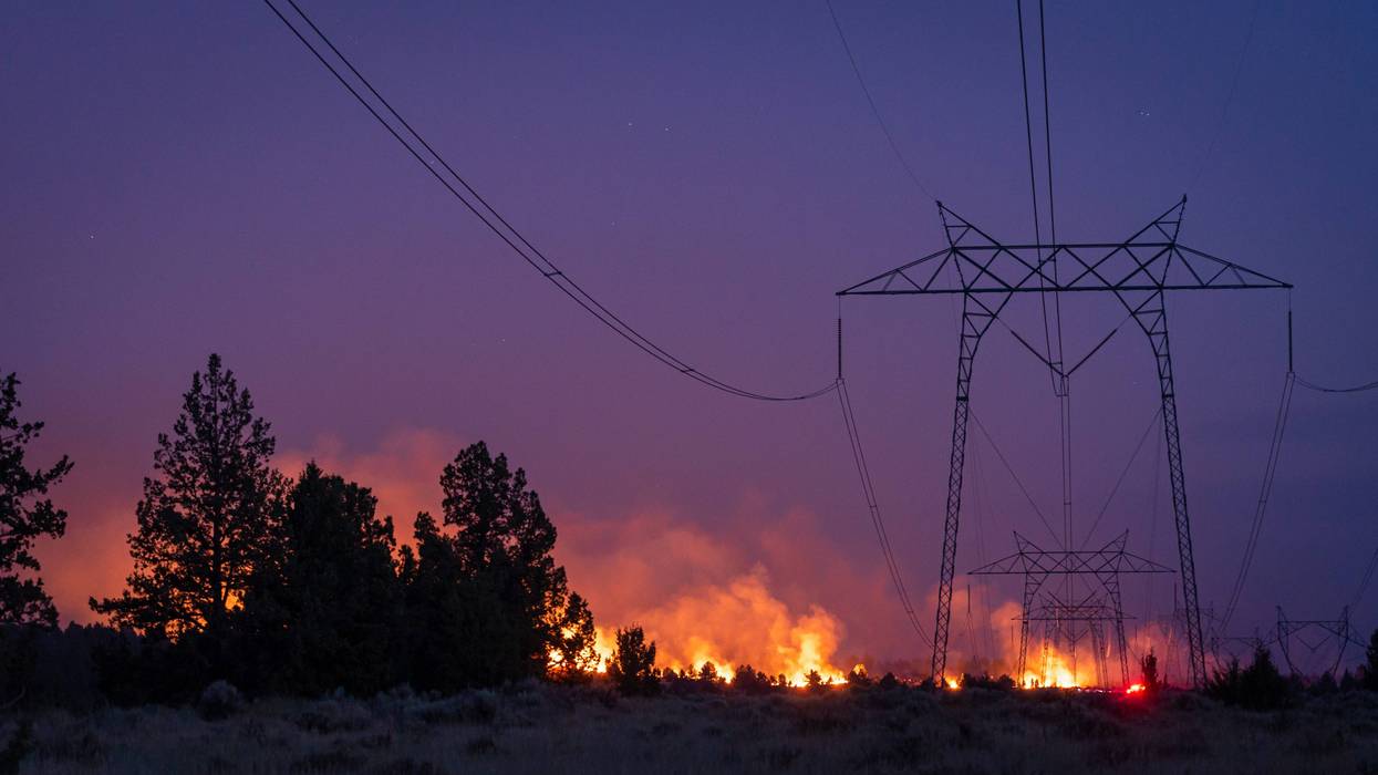 wildfire burns behind power lines