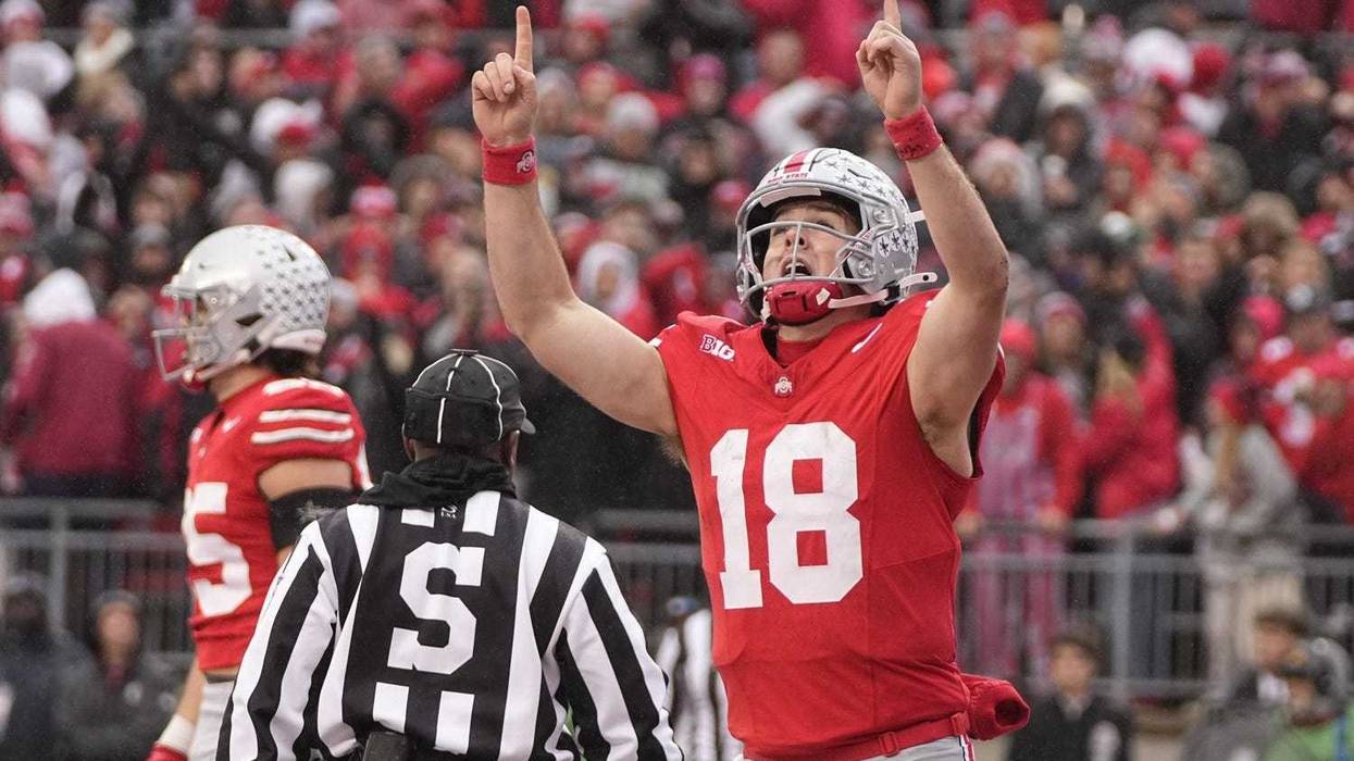 Will Howard pointing to the sky