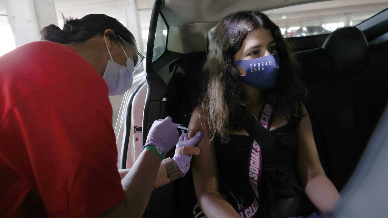 Willow Basta, 12, receives a Pfizer COVID-19 vaccination at a drive-thru vaccine clinic on May 13, 2021 in San Jose, California.