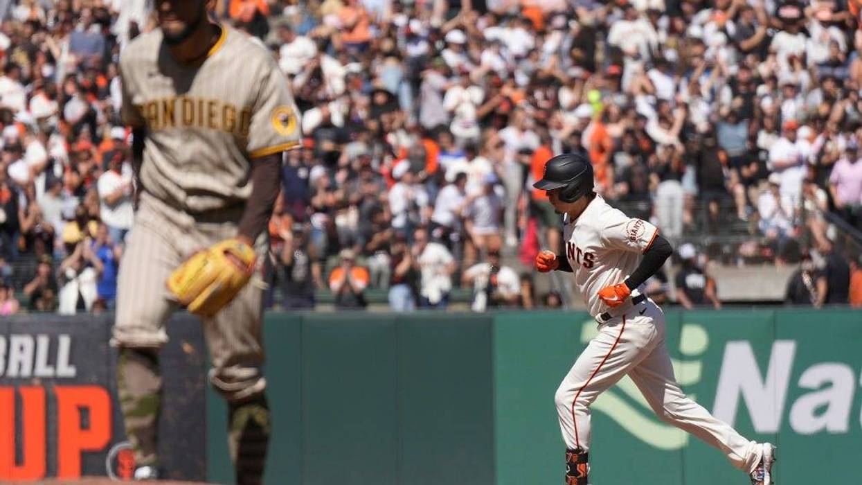 Wilmer Flores #41 of the San Francisco Giants trots around the bases after hitting a solo home run off of Robert Suarez #75 of the San Diego Padres in the bottom of the eighth inning at Oracle Park on May 21, 2022 in San Francisco, California.