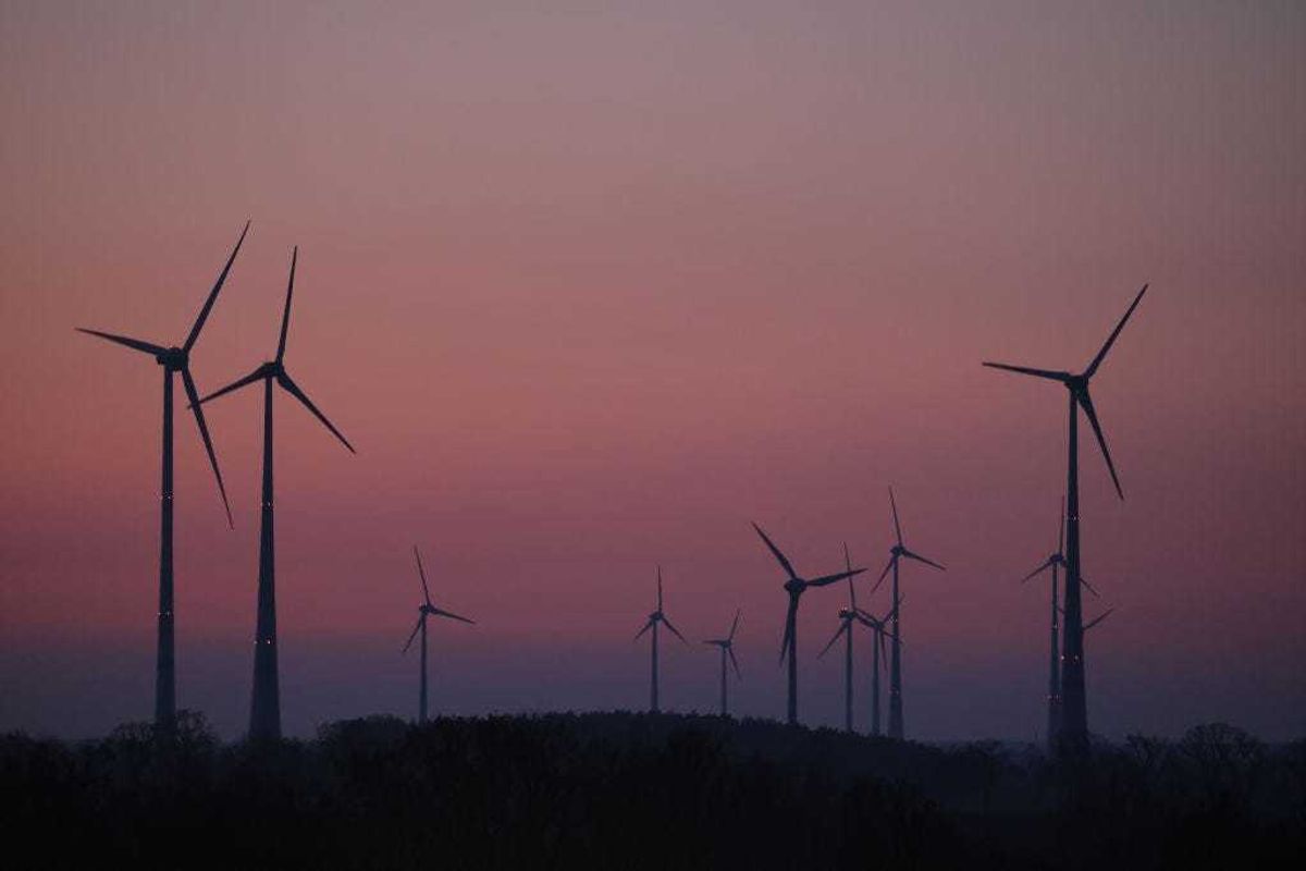 Wind turbines spin after sundown on March 24, 2022 near Mallnow, Germany. The German government, due to Russia's ongoing military invasion of Ukraine, is seeking to wean itself off of its heavy dependence on Russian oil, gas and coal imports. While it is contracting alternative fossil fuel sources for the short term, it is also planning to accelerate its long-term transition to renewable energy sources. (Photo by Sean Gallup/Getty Images)
