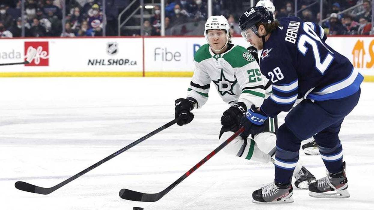 Winnipeg Jets defenseman Nathan Beaulieu (28) skates past Dallas Stars left wing Joel Kiviranta (25) in the first period at Canada Life Centre.