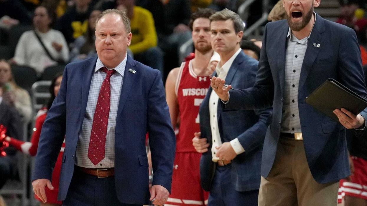 Wisconsin Badgers head coach Greg Gard (left) walks onto the court during a time out in the first half of the 2025 TIAA Big Ten Men’s Basketball Tournament final game against the Michigan Wolverines on Sunday, March 16, 2025, at Gainbridge Fieldhouse in Indianapolis. Michigan defeated Wisconsin 59-53.