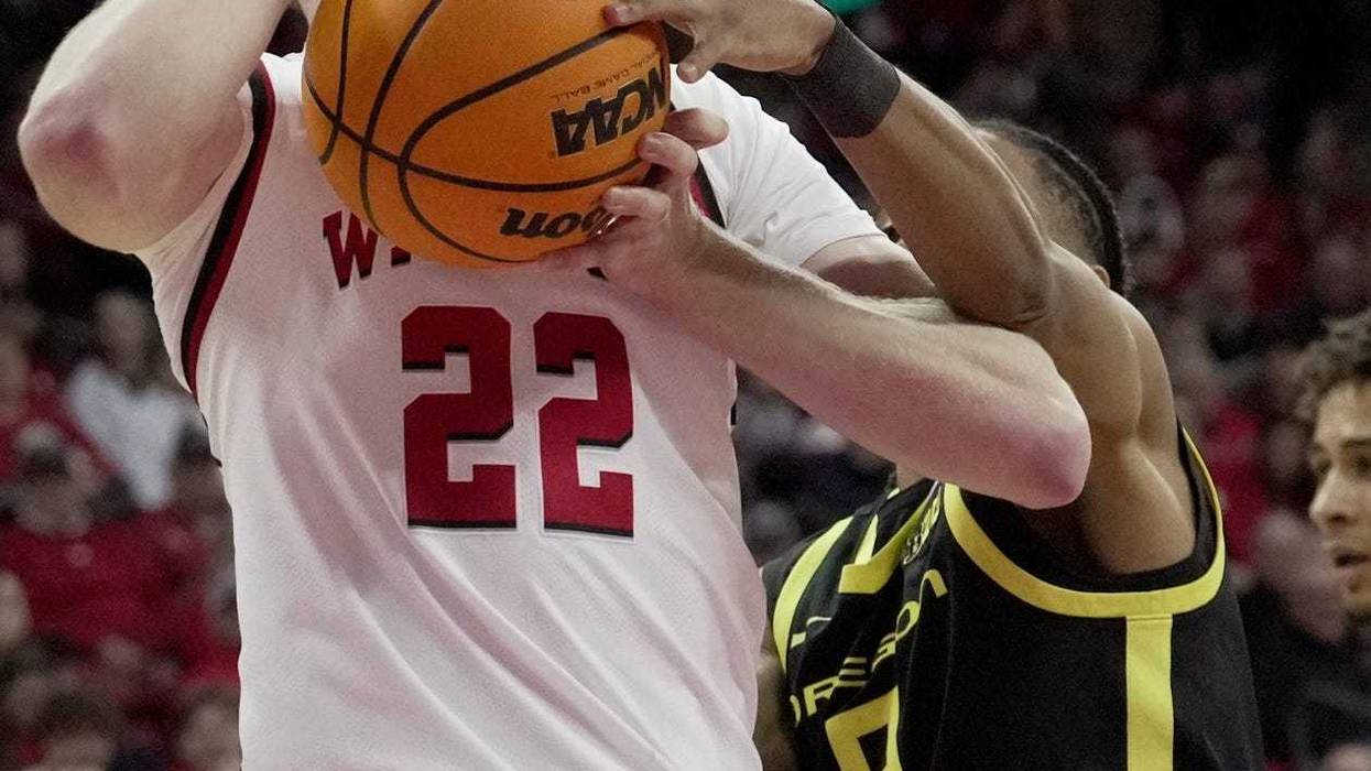 Wisconsin forward Steven Crowl (22) beat Oregon guard Keeshawn Barthelemy (9) to a rebound during the second half of their game Saturday, February 22, 2025 at the Kohl Center in Madison, Wisconsin. Oregon beat Wisconsin 77-73 in overtime.