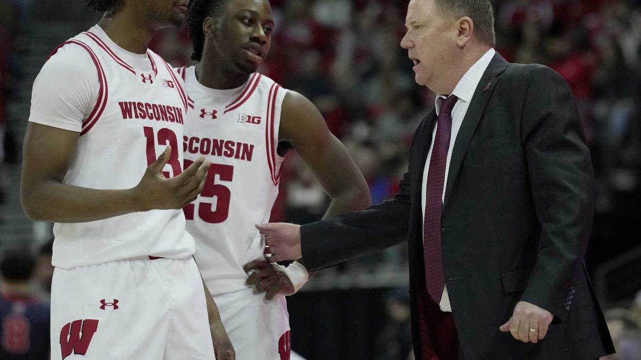 Wisconsin head coach Greg Gard talks two forward Xavier Amos (13) and guard John Blackwell (25) during the second half of their game Sunday, December 22, 2024 at the Kohl Center in Madison, Wisconsin. Wisconsin beat Detroit Mercy 76-53.