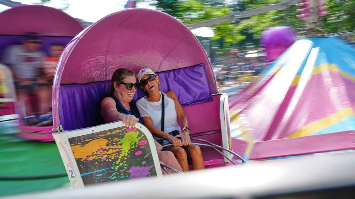 With screams and giggles, whipping ponytails and white-knuckle grips, Minnesota fairgoers are taking delight in the magic of the Tilt-A-Whirl ride as it turns 100 years old.