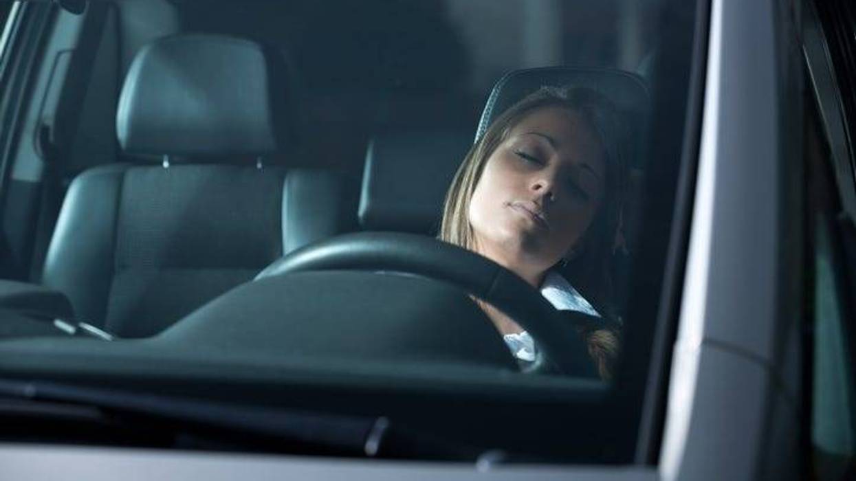 woman asleep behind the wheel
