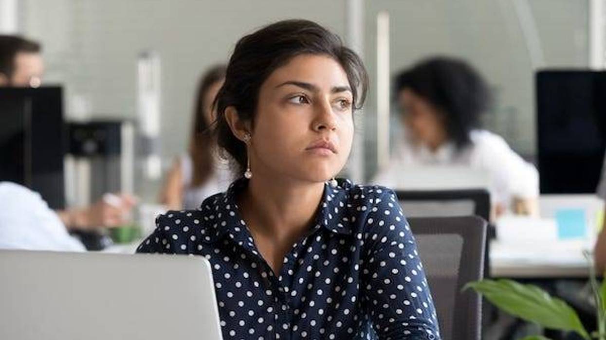 Woman at work looking away looking forlorn