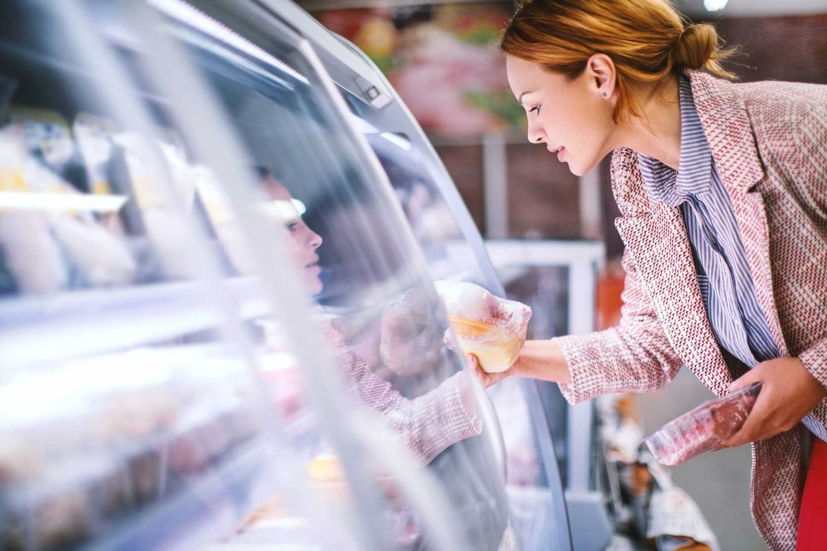Woman buying meat at a store.