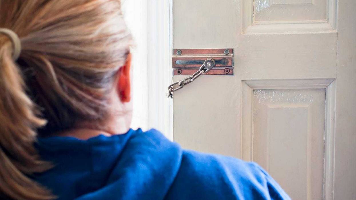 Woman checking door stock photo.