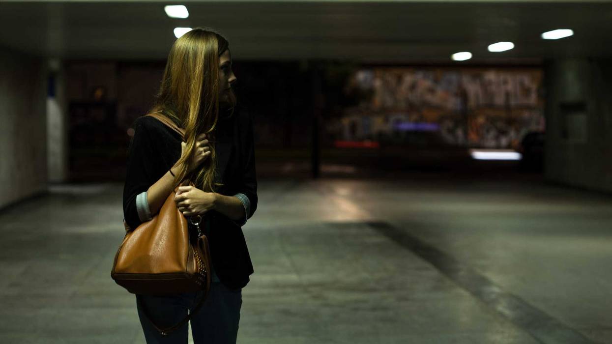 woman clutching purse in parking garage