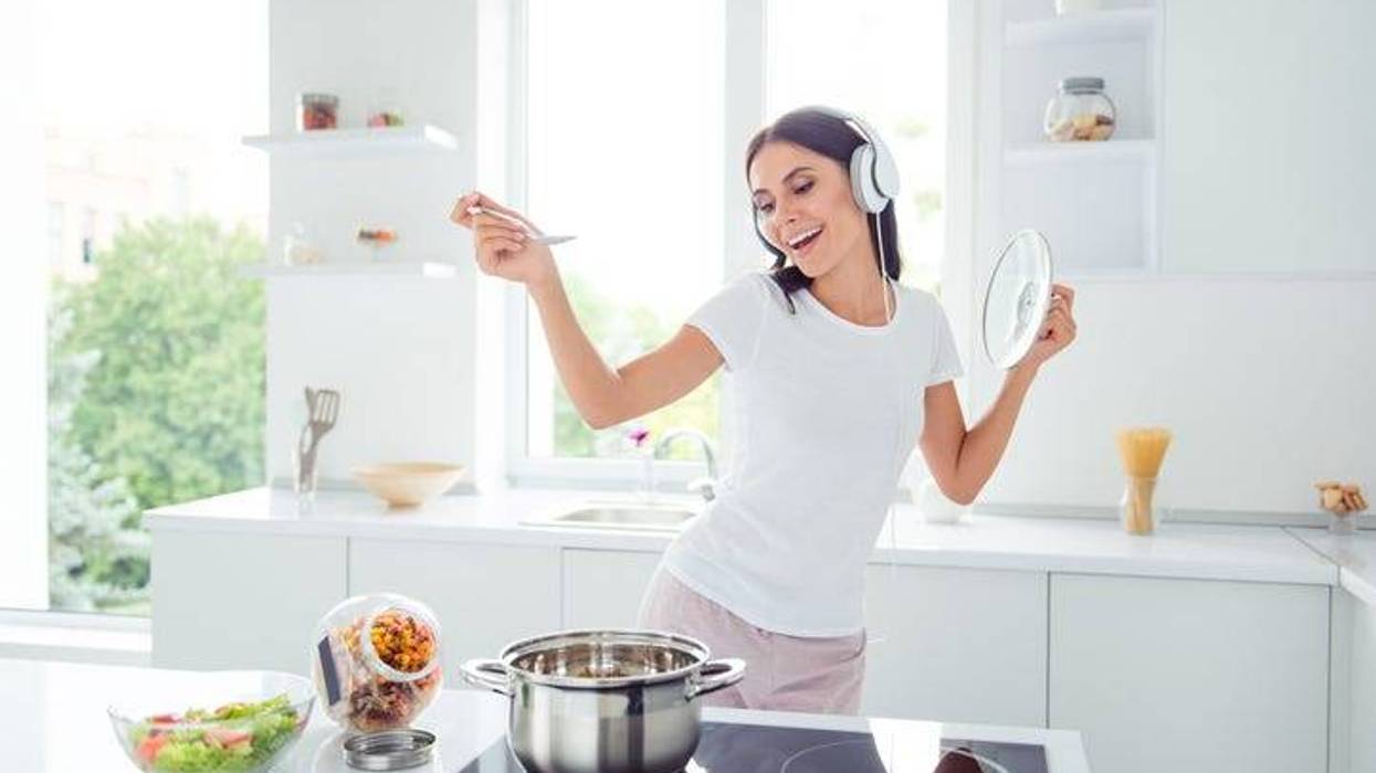 Woman cooking and listening to music