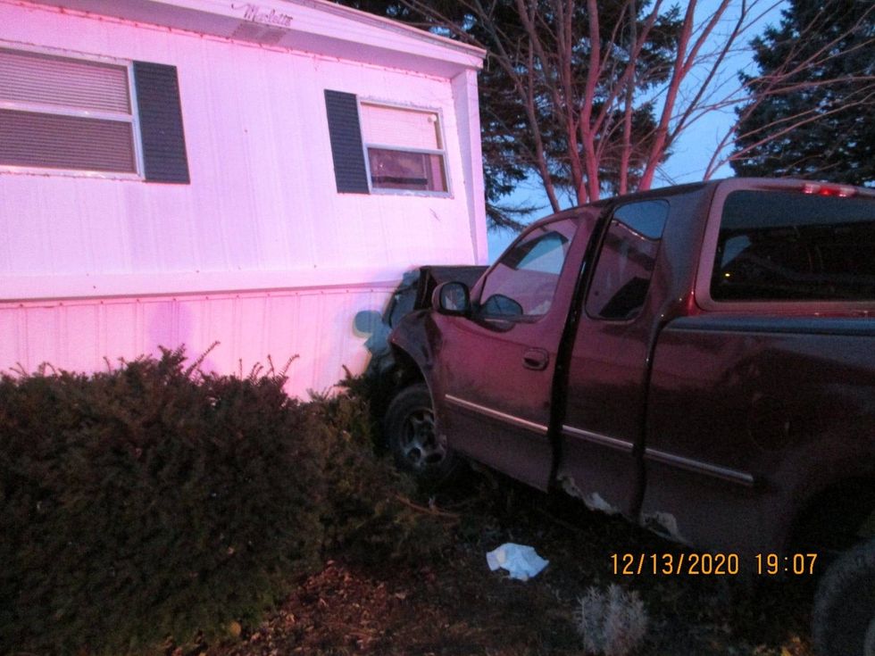 woman crashes pickup into mobile home