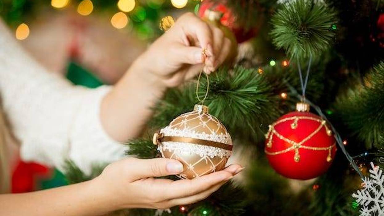Woman decorating a Christmas tree