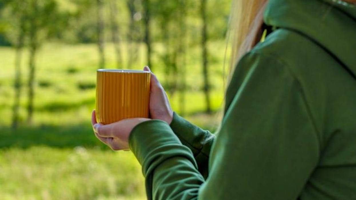 woman drinking coffee weather a hoodie