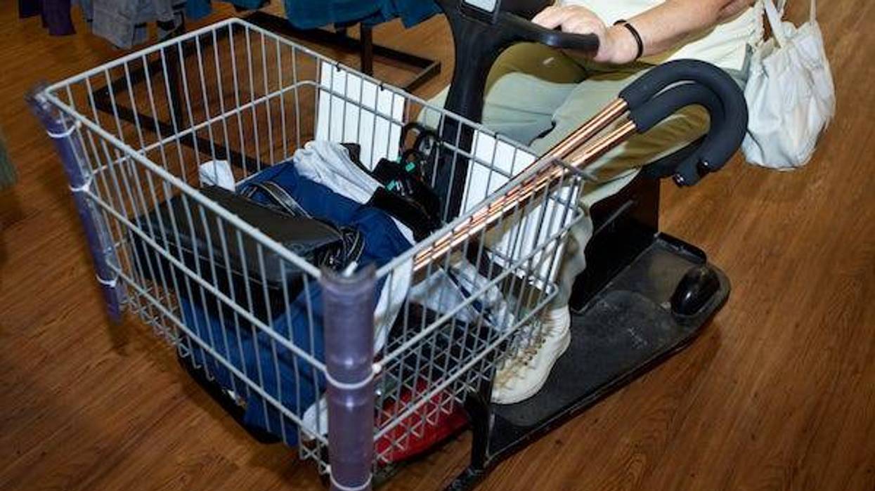 Woman driving motorized cart through store