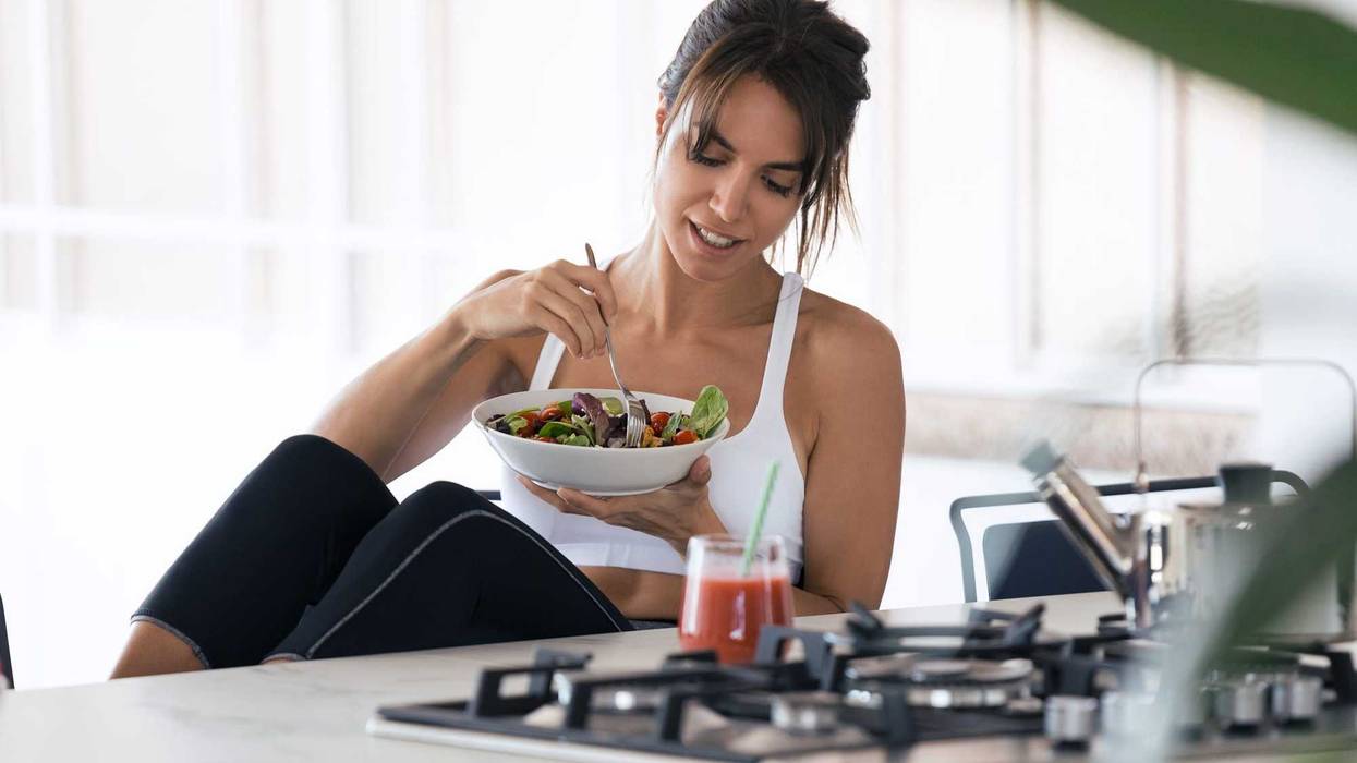 woman eating breakfast in workout gear.
