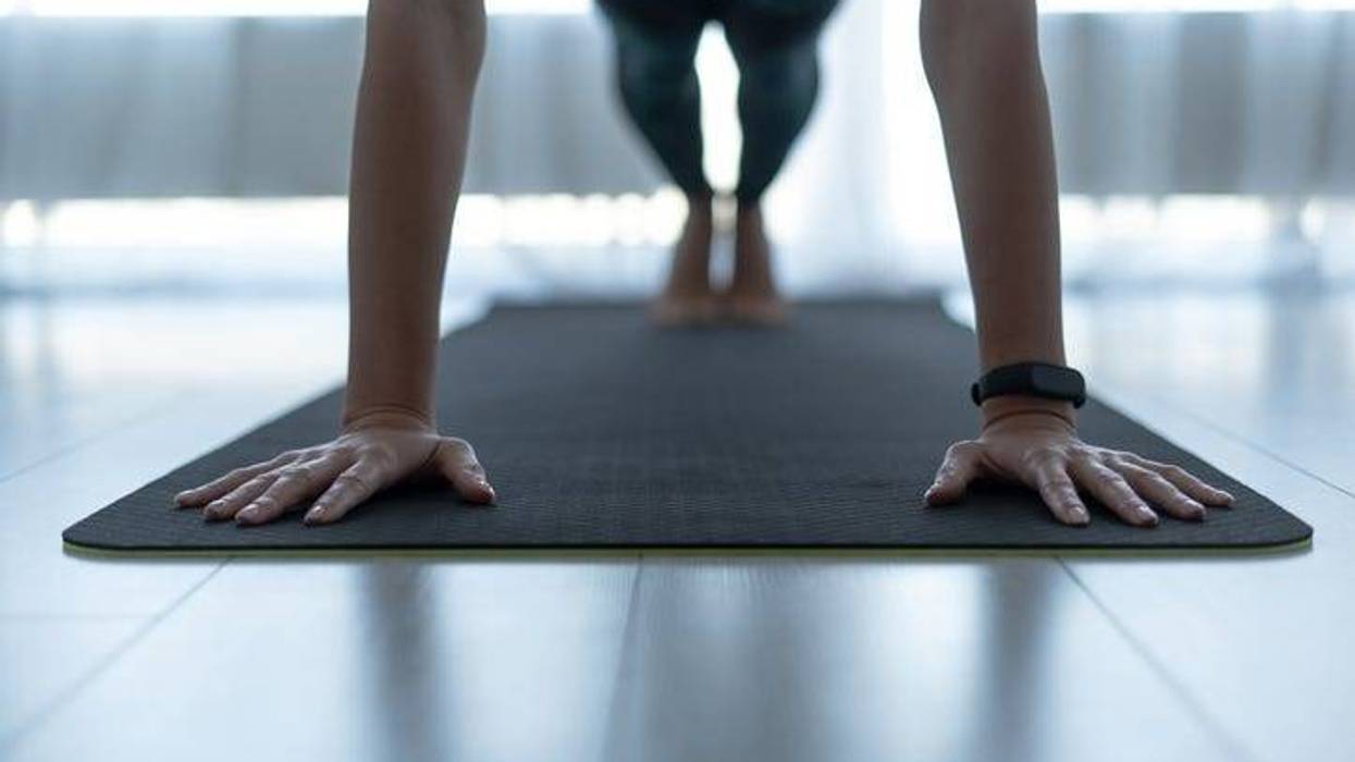 Woman exercising on fitness mat