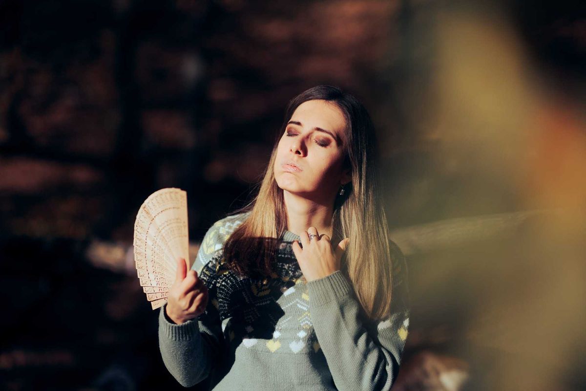 Woman fanning herself.