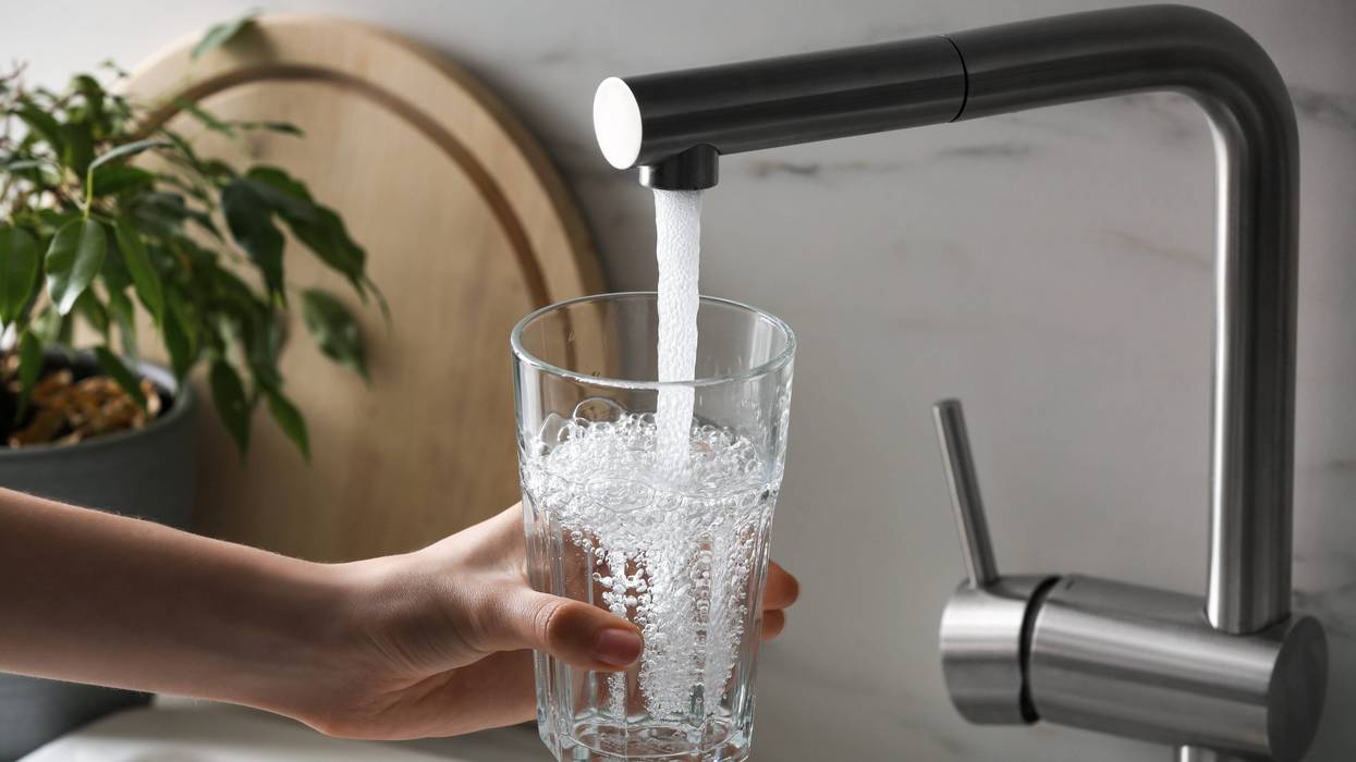 woman filling glass at tap
