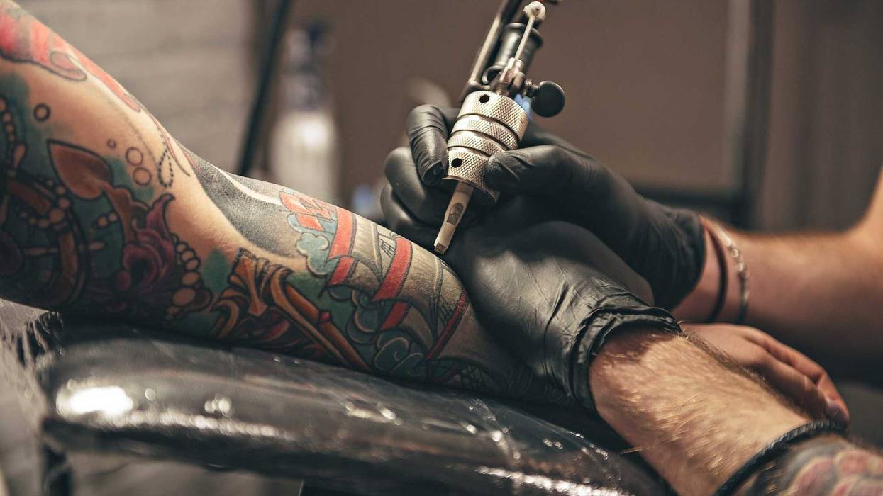 Woman getting tattoo added to her sleeve
