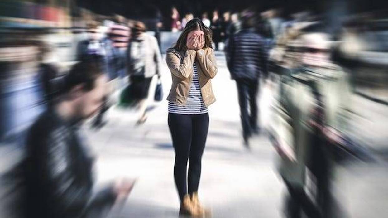 Woman having a panic attack in the middle of a crowd