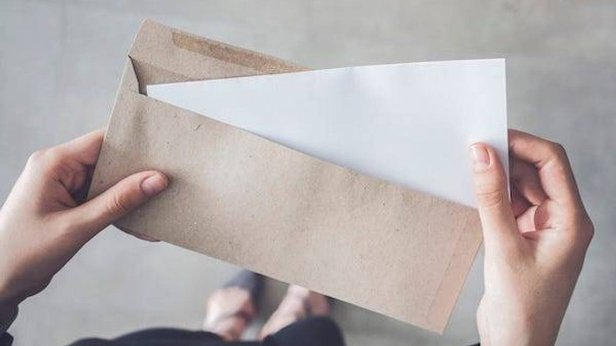 Woman holding a letter in an envelope