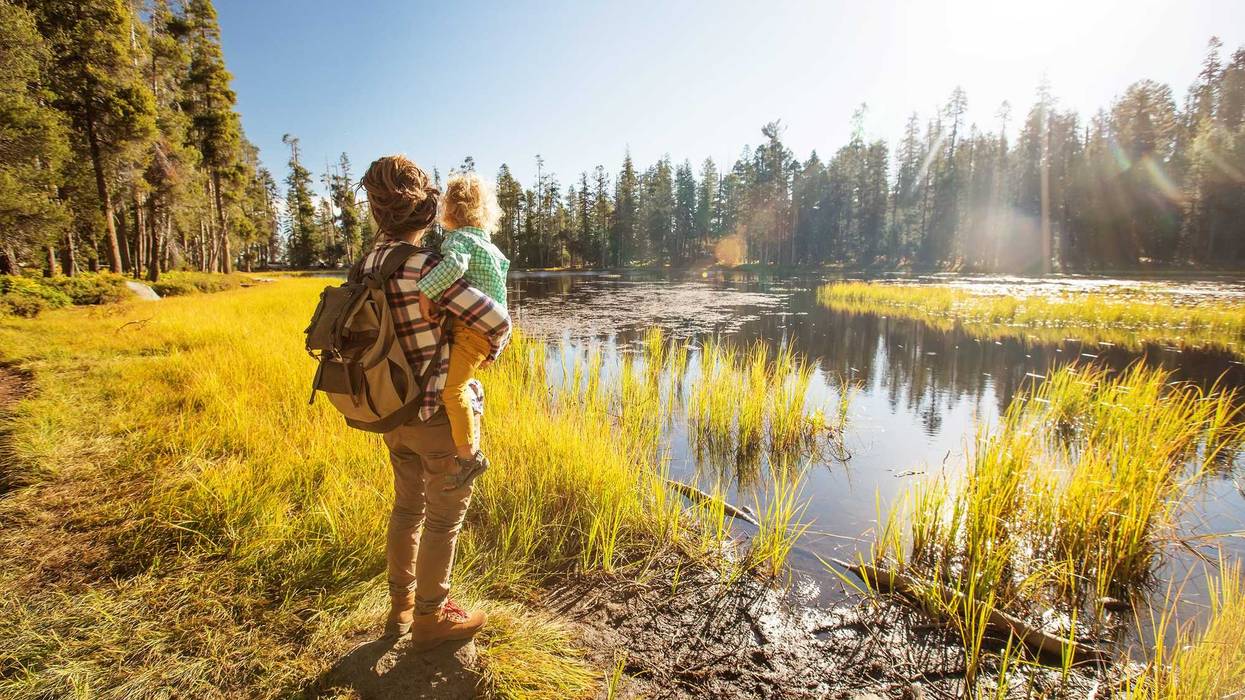 Woman holding baby while hiking