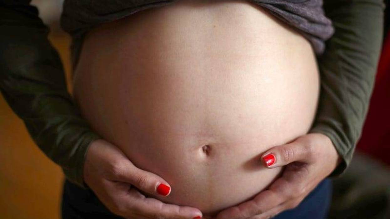 Woman holding pregnant belly