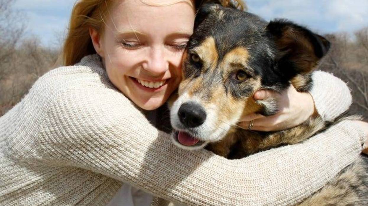 Woman Hugging German Shepherd Dog